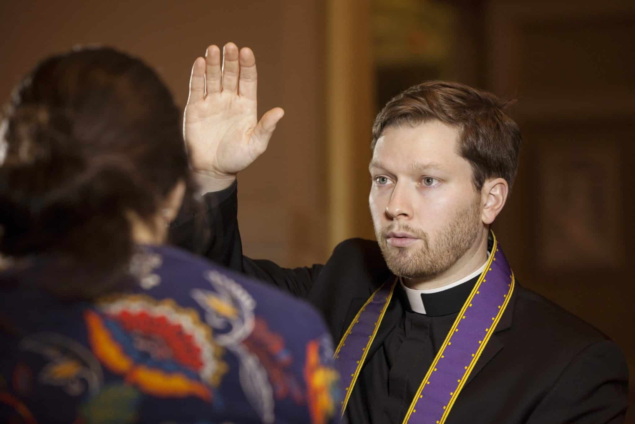 Father Kevin Regan of the Archdiocese of Washington demonstrates the granting of absolution that occurs during the sacrament of reconciliation. The priest, acting in the person of Christ, can absolve a person of their sins with their contrition, confession and penance. (CNS photo/Nancy Phelan Wiechec) (Feb. 5, 2013) See LENT-CONFESSION Jan. 30, 2013. Editors: Photo was taken for the purpose of illustration and not during an actual confession.