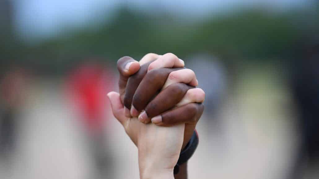 A man and woman hold hands in London's Hyde Park during a "Black Lives Matter" protest June 3, 2020, following the death of George Floyd, an African American man who was taken into custody by Minneapolis police and later died at a Minneapolis hospital. (CNS photo/Dylan Martinez, Reuters)