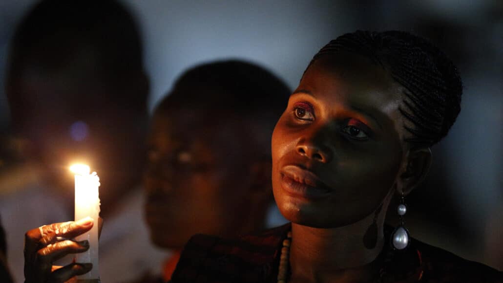 A woman holds a candle as Pope Francis attends a meeting at the Munyonyo shrine in Kampala, Uganda Nov. 27. The pope met with catechists and teachers at Munyonyo, the martyrdom spot of the Uganda Martyrs. (CNS photo/Paul Haring)