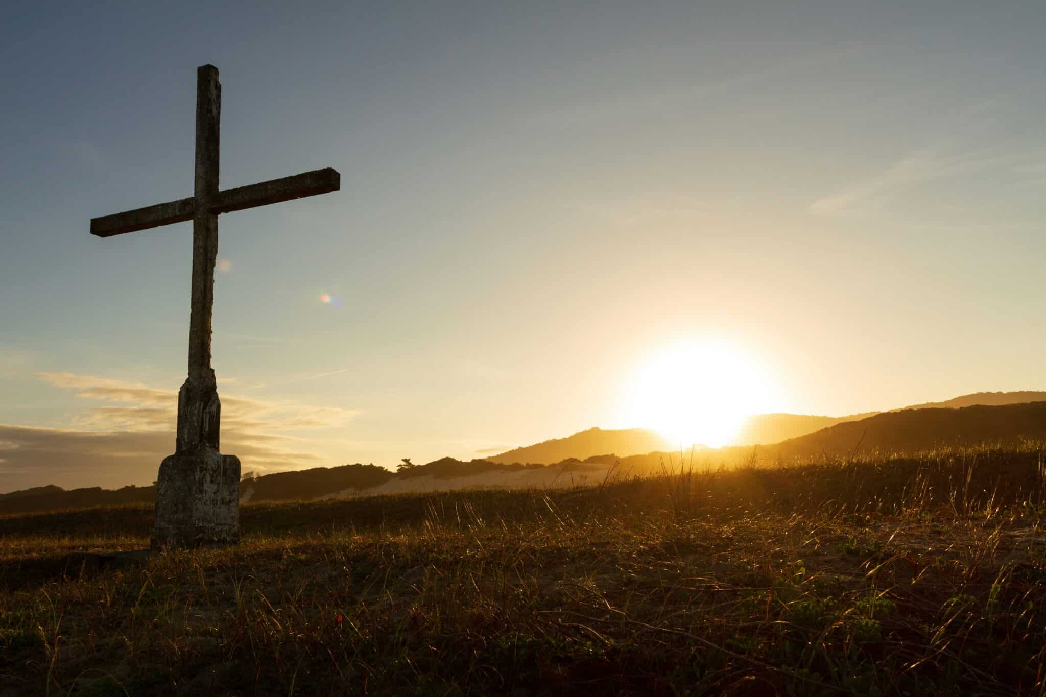 cross in a field | Photo by CRISTIANO DE ASSUNÇÃO on Unsplash