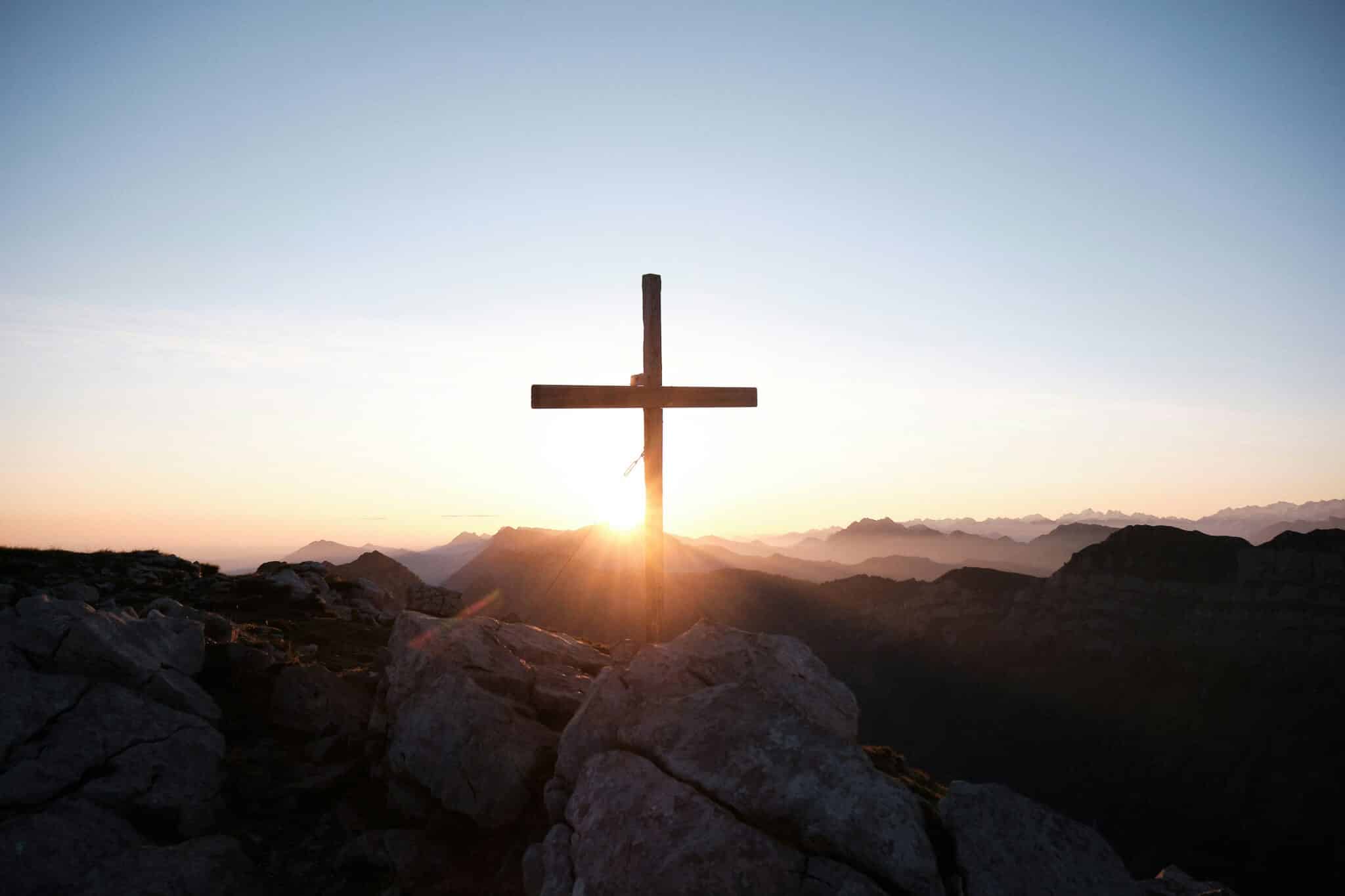 Cross and a valley | Photo by Yannick Pulver on Unsplash