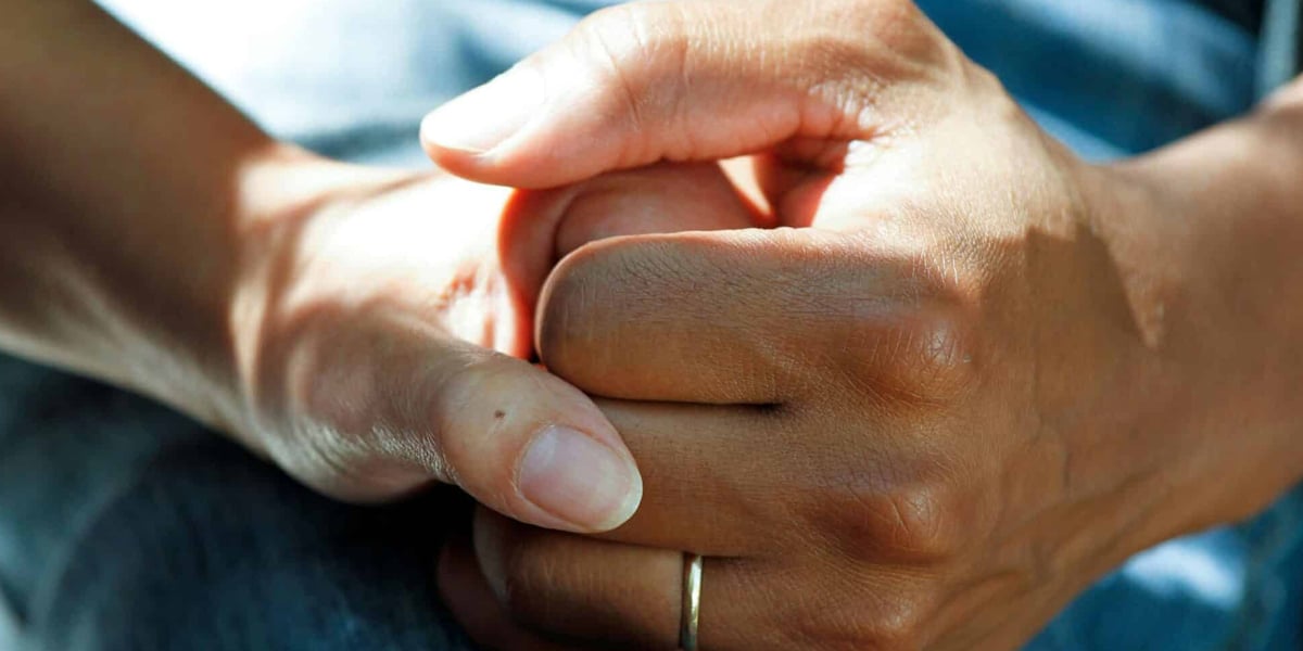 hands clasped in prayer