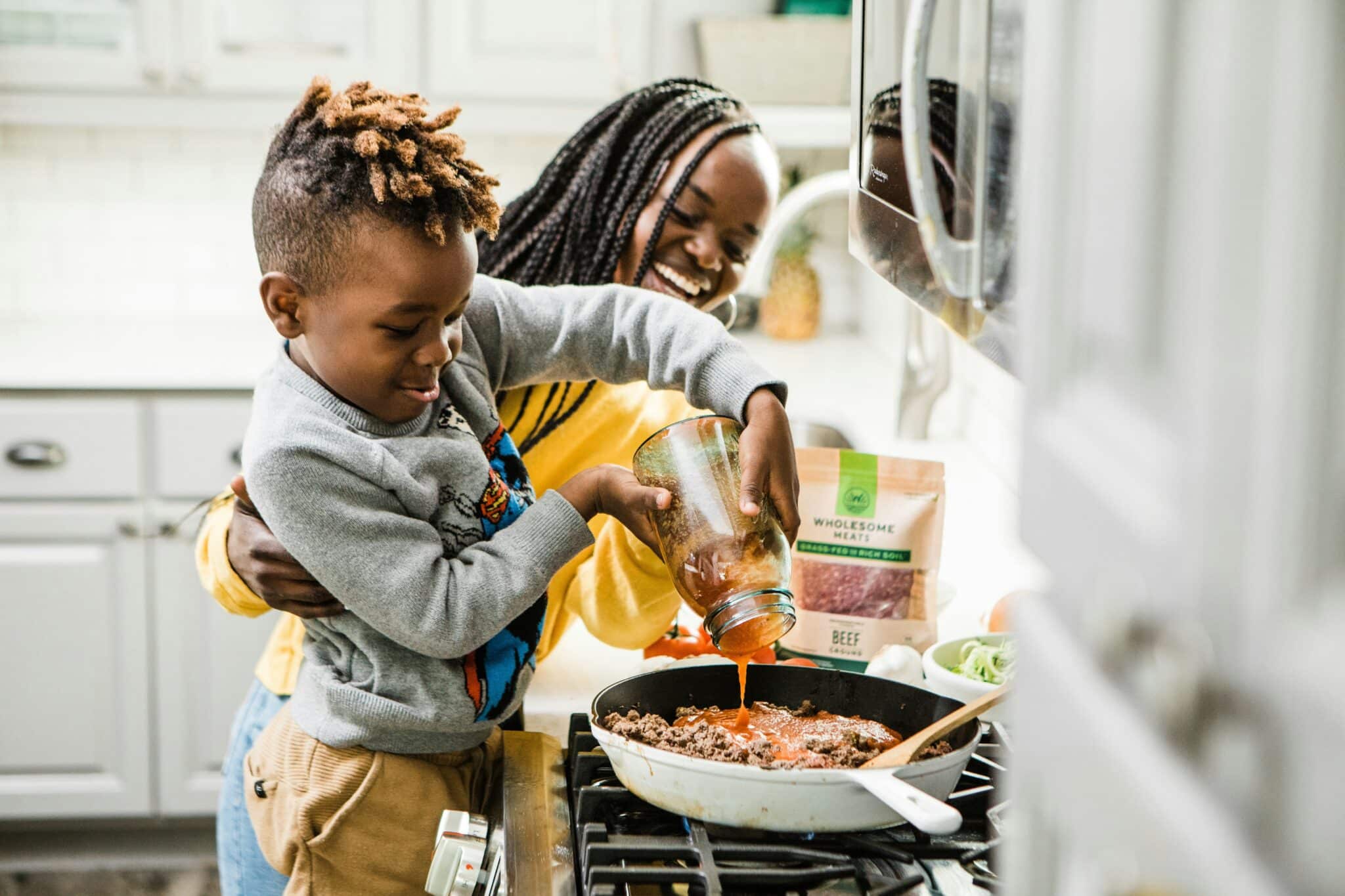Mother and son cooking | Photo by Brooke Lark on Unsplash