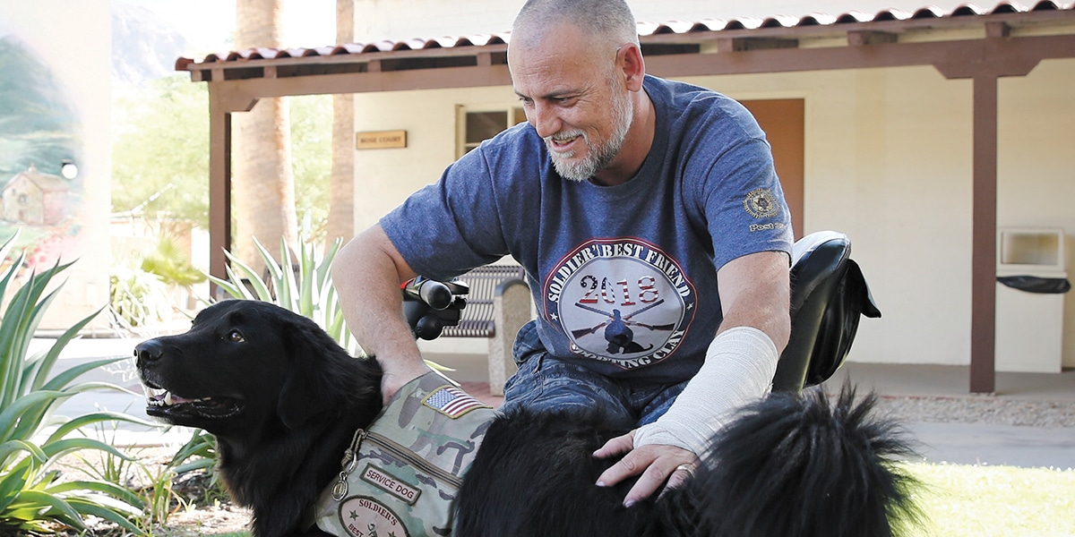 injured veteran taking care of dog