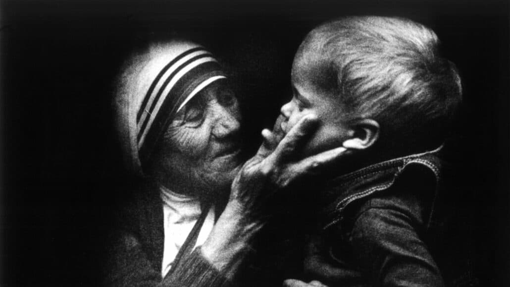 Mother Teresa embraces a child