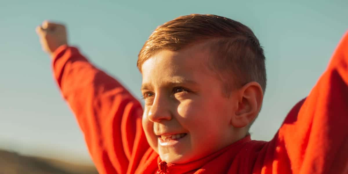 Happy kid with arms raised