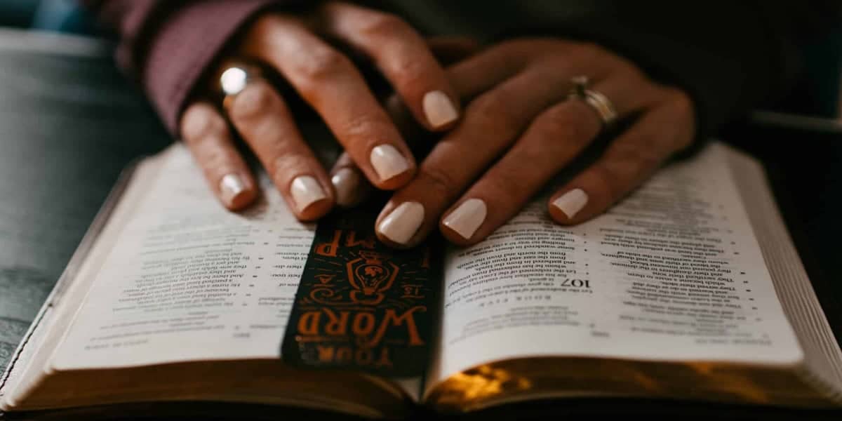 woman with hands on bible