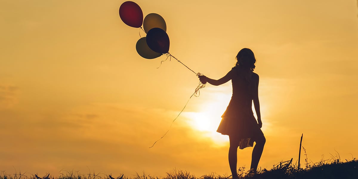 Woman holding ballons