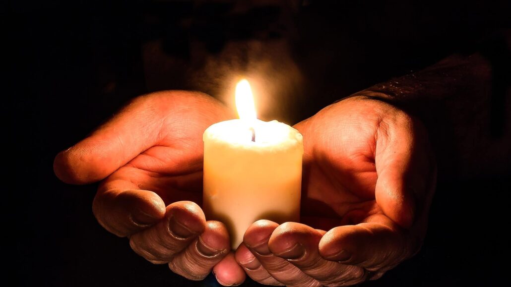 hands holding a candle