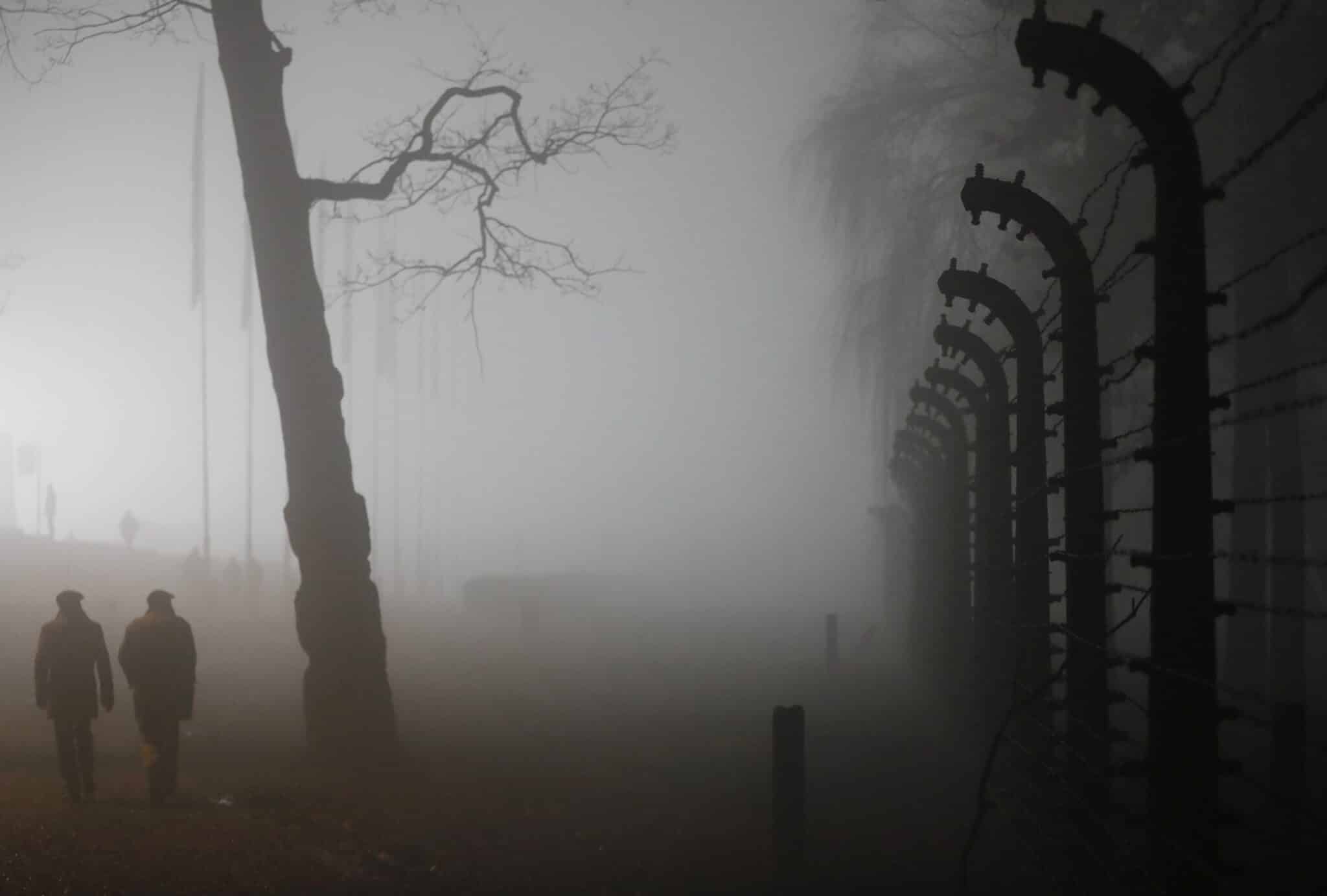 People walk in dense fog in the Auschwitz-Birkenau Nazi death camp during ceremonies in late January marking the 73rd anniversary of the liberation of the camp and International Holocaust Victims Remembrance Day in in Oswiecim, Poland. (CNS photo/Kacper Pempel, Reuters)
