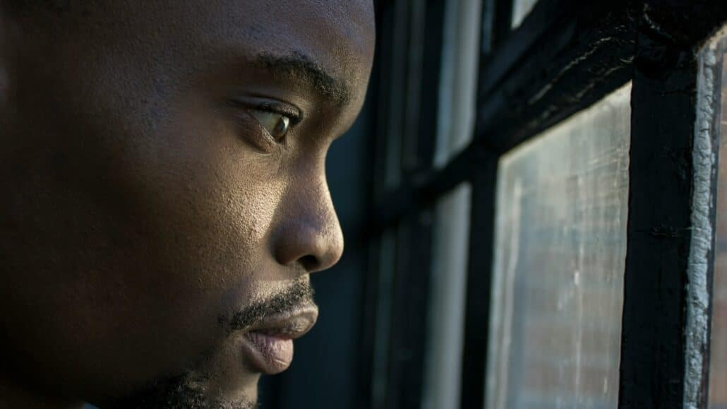 Man staring out the window | Photo by Anaya Katlego on Unsplash