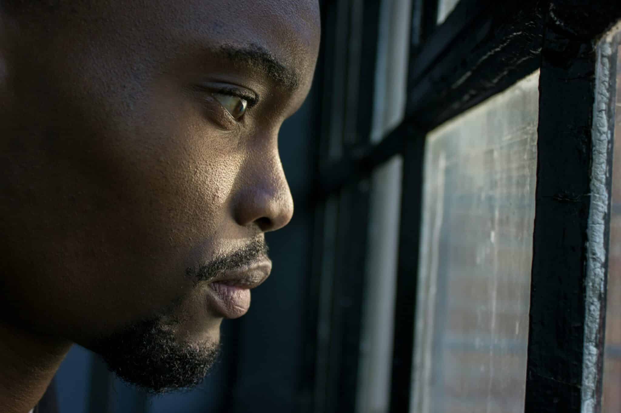Man staring out the window | Photo by Anaya Katlego on Unsplash