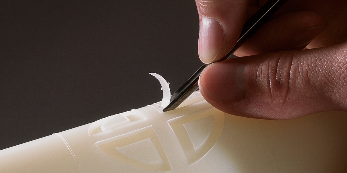 carving a design into a candle