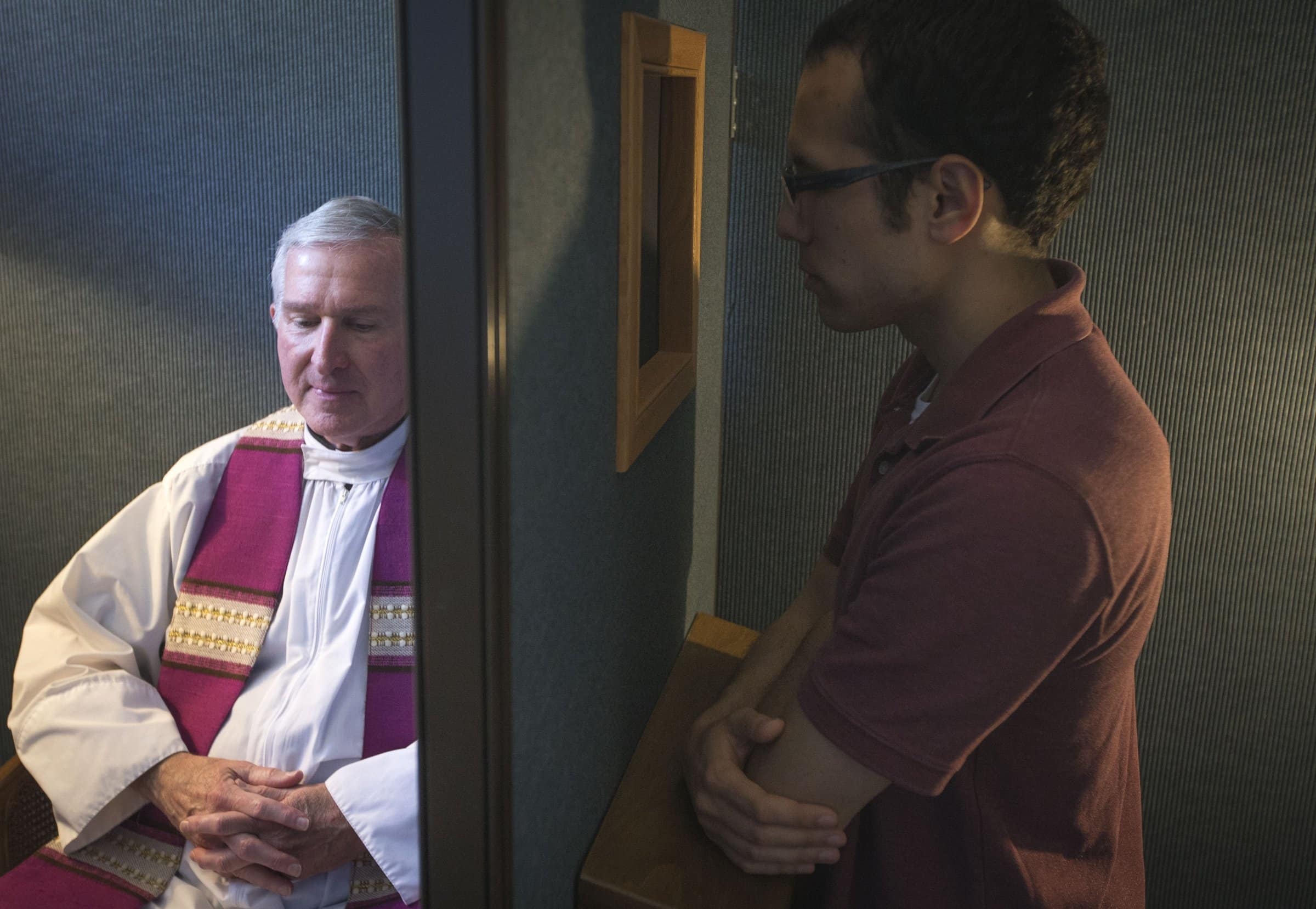 Father Timothy J. Mockaitis, pastor of Queen of Peace Catholic Church in Salem, Ore., and penitent Ethan K. Alano of Salem demonstrate how a confession is conducted May 3, 2019. The sacrament of reconciliation provides us with opportunities to continue to examine our intentions and conscience, to "come clean" with God so we may move ahead refreshed, abundantly blessed. (CNS photo/Chaz Muth)