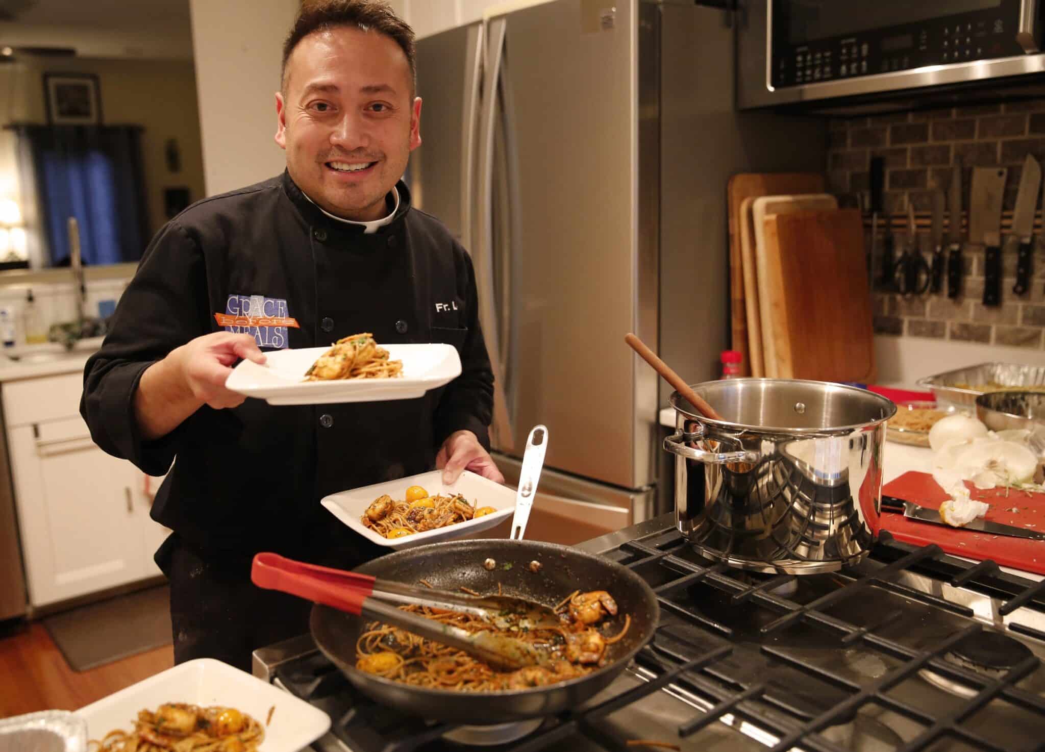 Celebrity chef Father Leo Patalinghug displays a Lenten seafood pasta meal he prepared in his Baltimore kitchen Feb. 24, 2016. During a Nov. 22, 2019, session at the National Catholic Youth Conference in Indianapolis, Father Patalinghug, better known as the "the cooking priest," provided a different kind of recipe, "Five Steps to Become a Teenage Saint," to help youths get to heaven. (CNS photo/Chaz Muth)