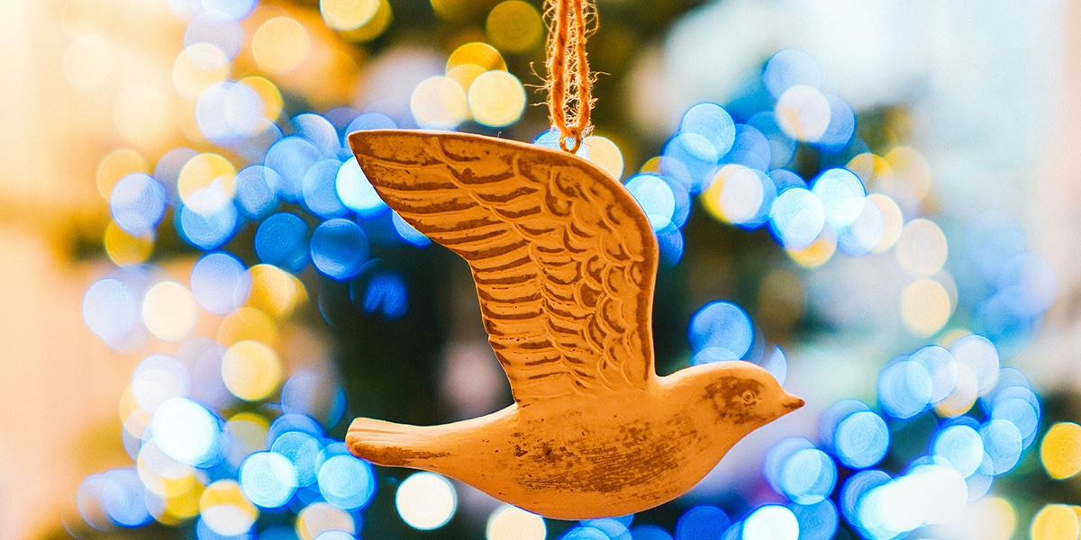 dove ornament near a christmas tree