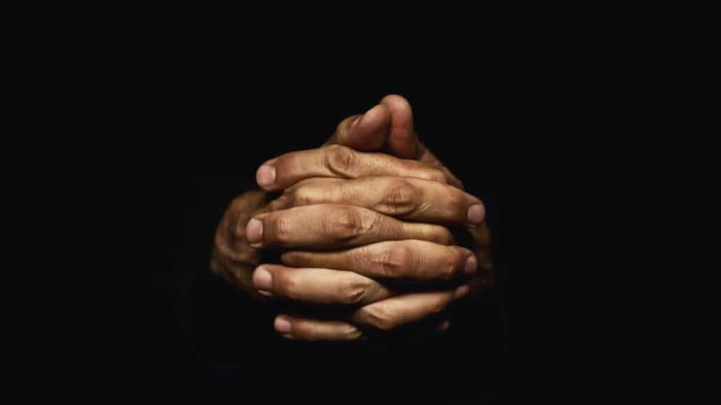 hands clasped together in prayer