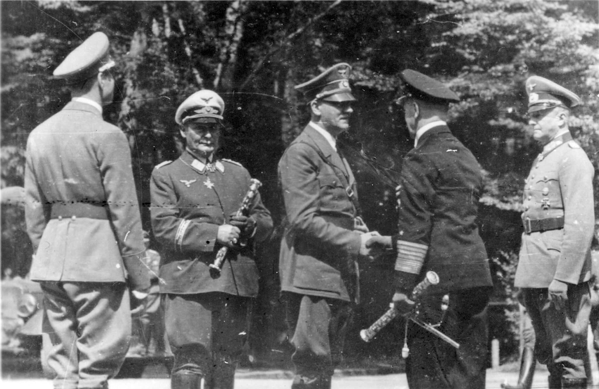 A historical photograph shows Adolf Hitler, center, greeting an officer in the French village of Compiegne June 22, 1940, after France surrendered to Nazi Germany. Germany's Catholic bishops marked the upcoming 75th anniversary of the end of World War II by issuing a statement criticizing the behavior of their predecessors under the Nazis. (CNS photo/Patrick Kovacs, Reuters)