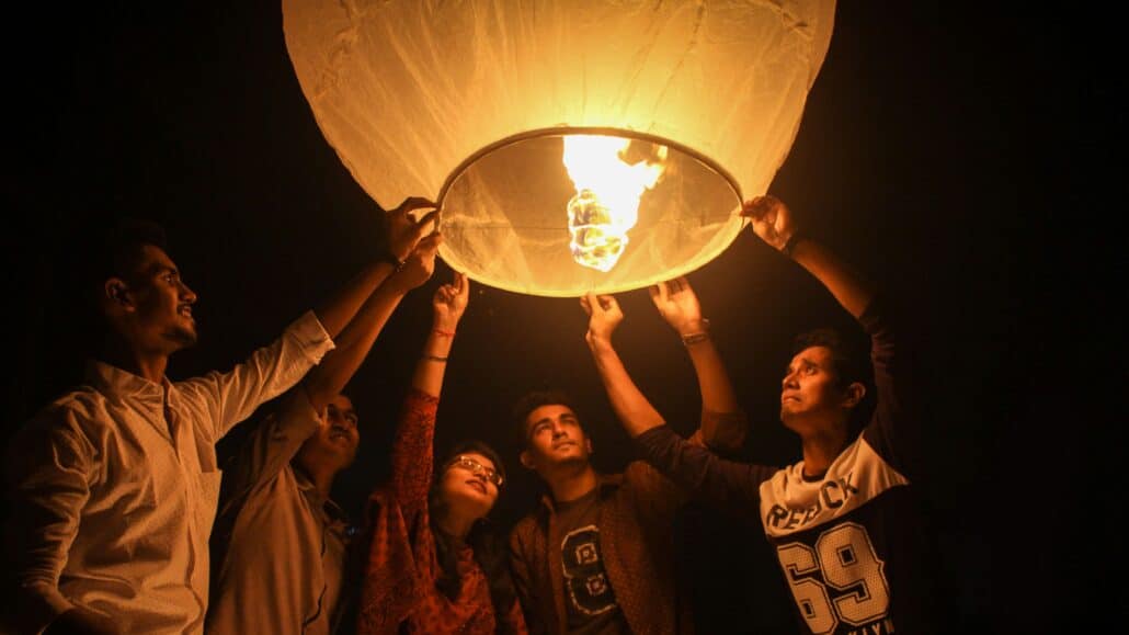 people holding a lantern | Photo by Sourabh Barua on Unsplash