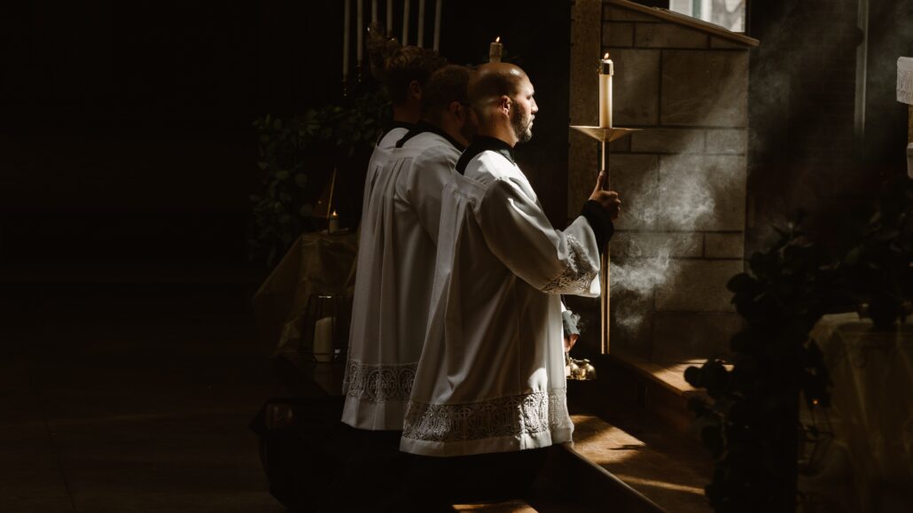 Priests kneeling at Mass