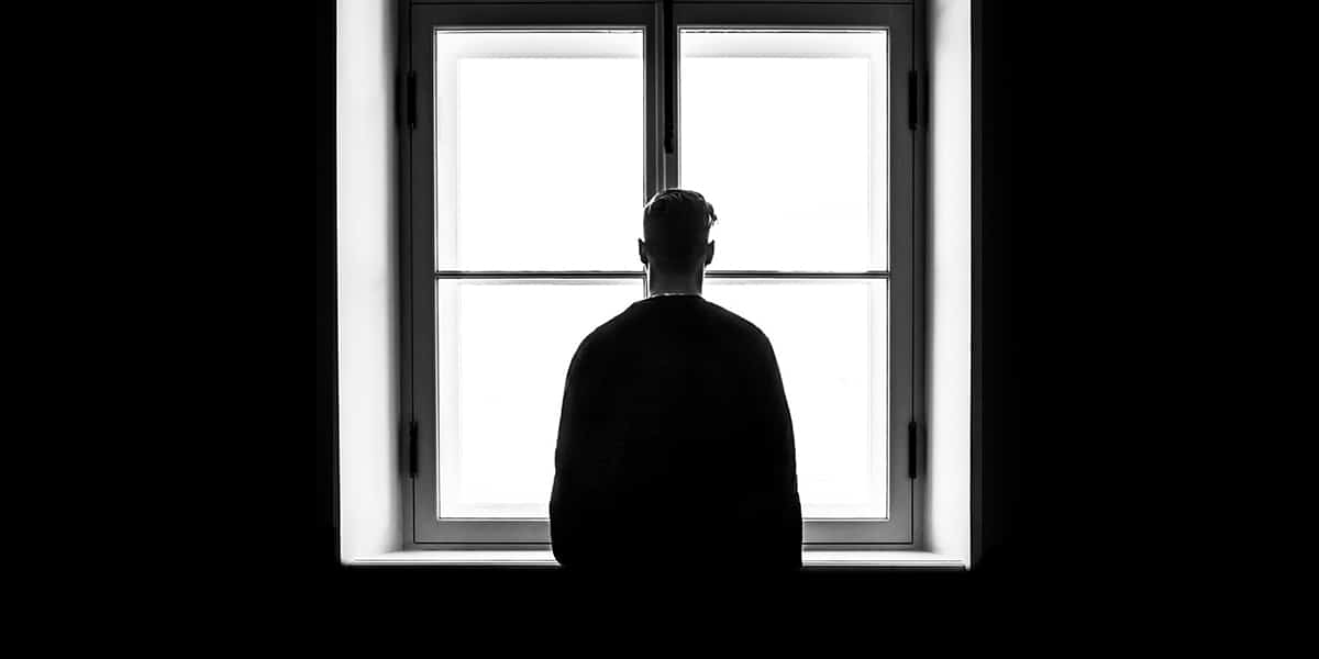 man looking out a window