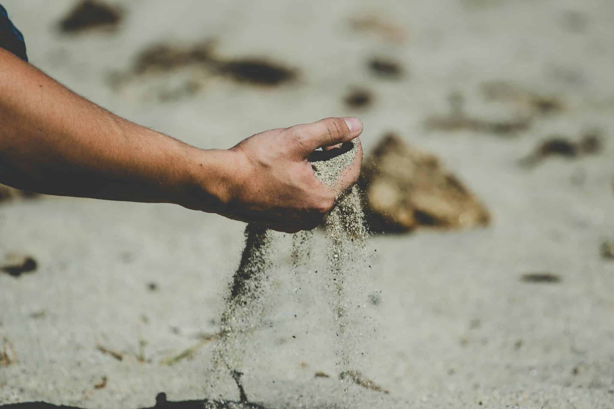 sand in the hand | Photo by Elijah Hiett on Unsplash