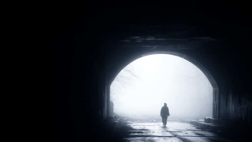 Walking through a tunnel | Photo by Chris Buckwald on Unsplash
