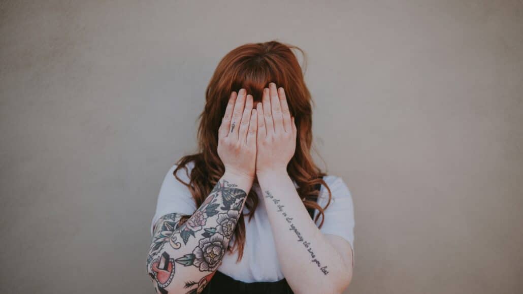 woman covering her face | Photo by Annie Spratt on Unsplash