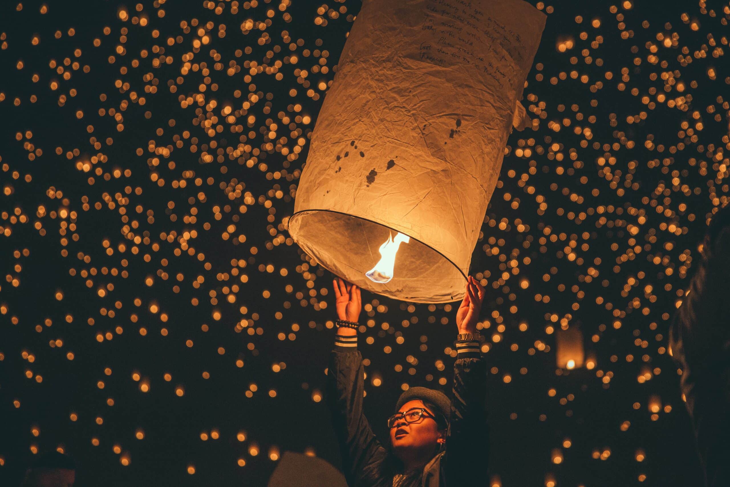 woman holding a lantern | Photo by Austin Neill on Unsplash