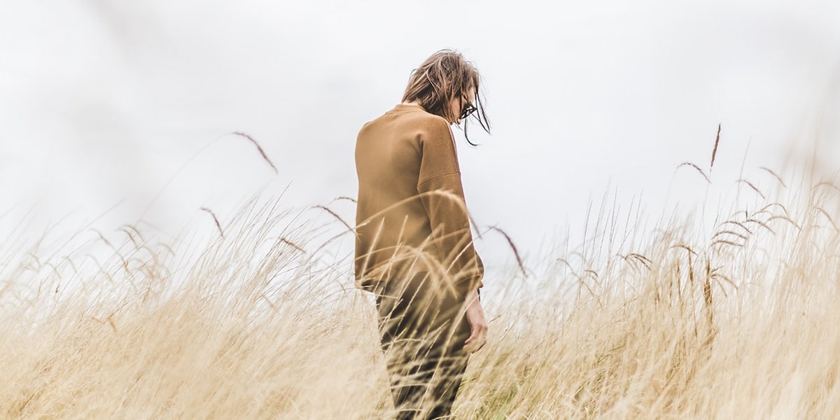 Woman walking in tall grasses