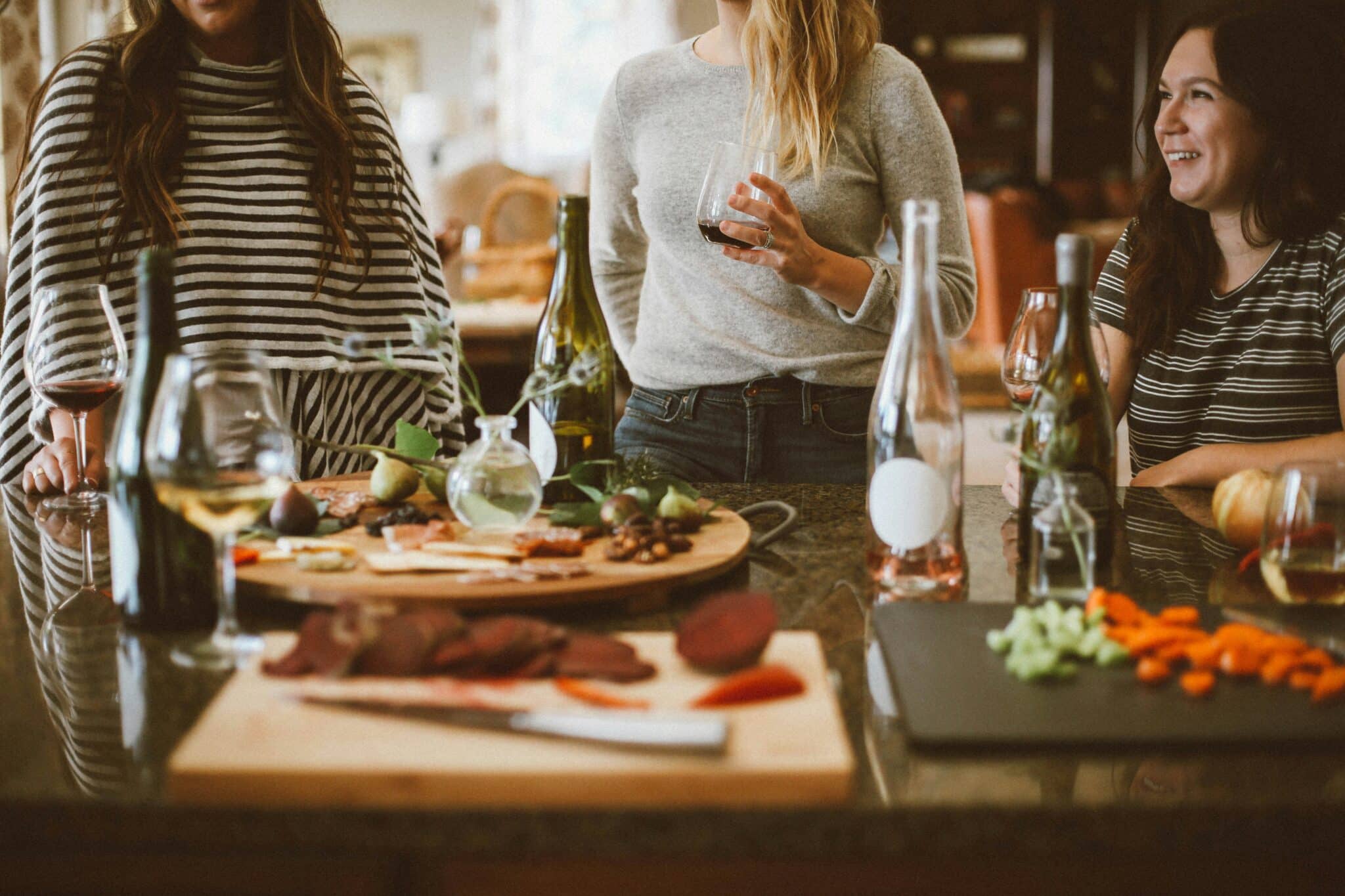 Women in the kitchen laughing | Photo by Kelsey Chance on Unsplash