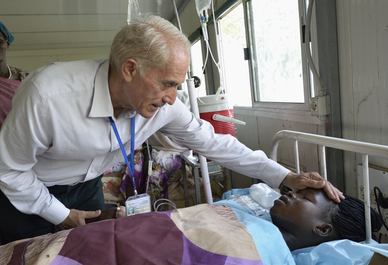 Maryknoll Father Mike Bassano blesses Veronica Bol, a displaced woman who just gave birth to twins, in an Indian army hospital inside a U.N. base in Malakal, South Sudan, April 8. (CNS photo/Paul Jeffrey)