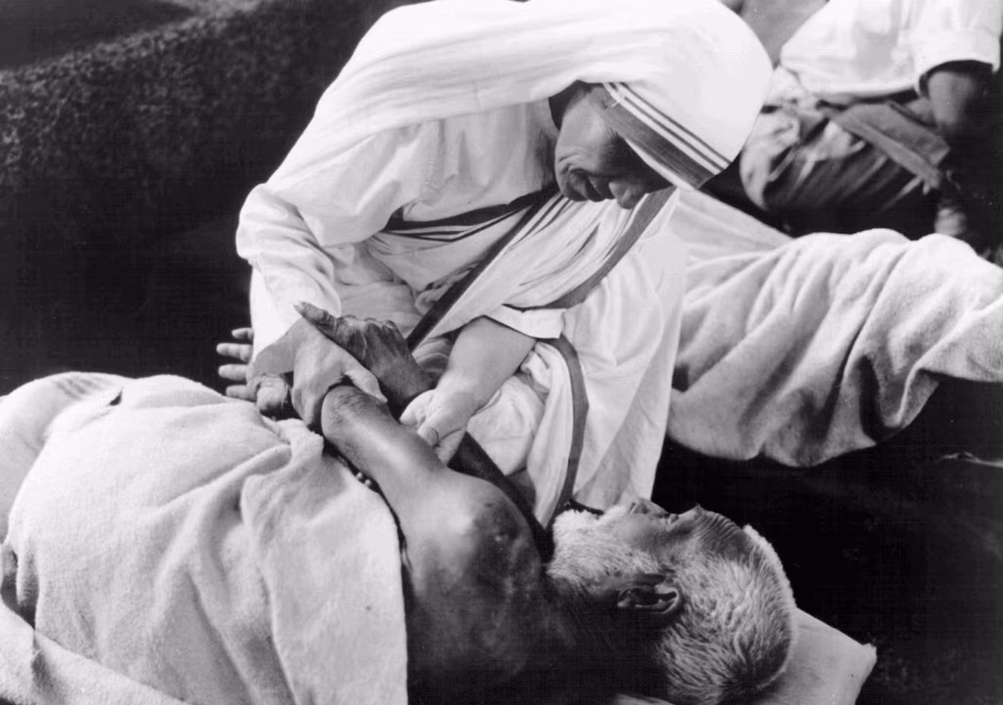 St. Teresa of Kolkata gives comfort to a sick man at the Missionaries of Charity home in Kolkata, India, in this undated photo. (OSV News photo/KNA)