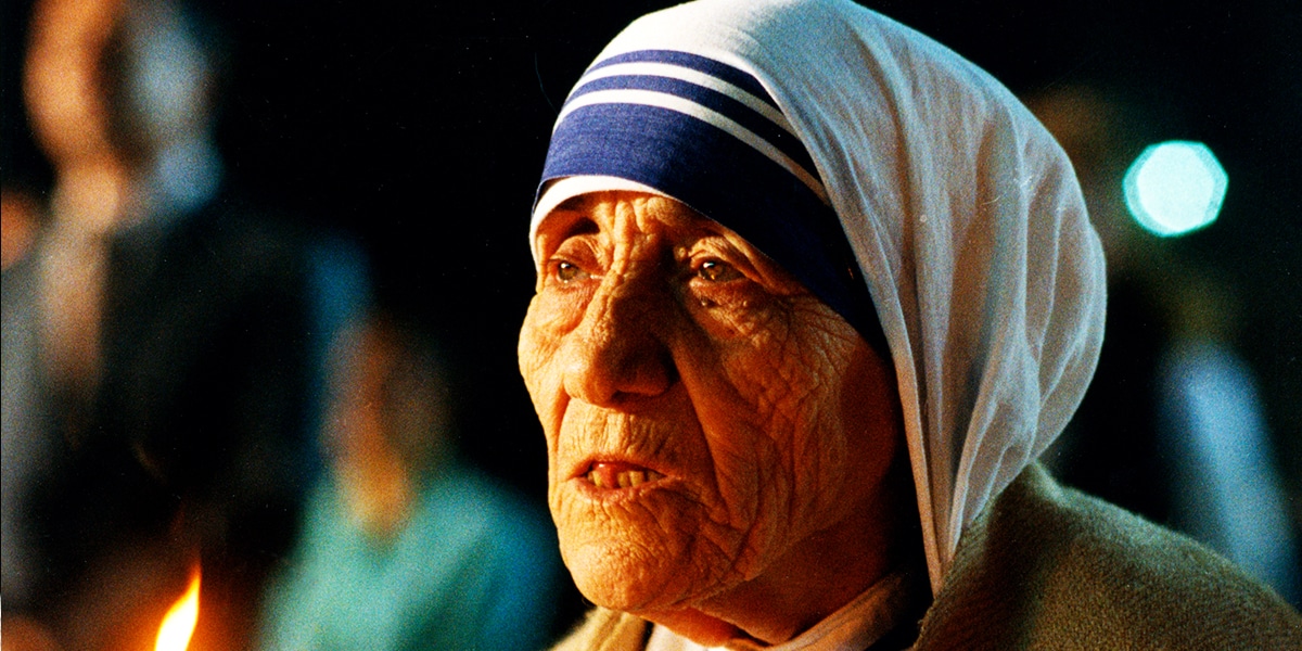 Mother Teresa praying by candle light