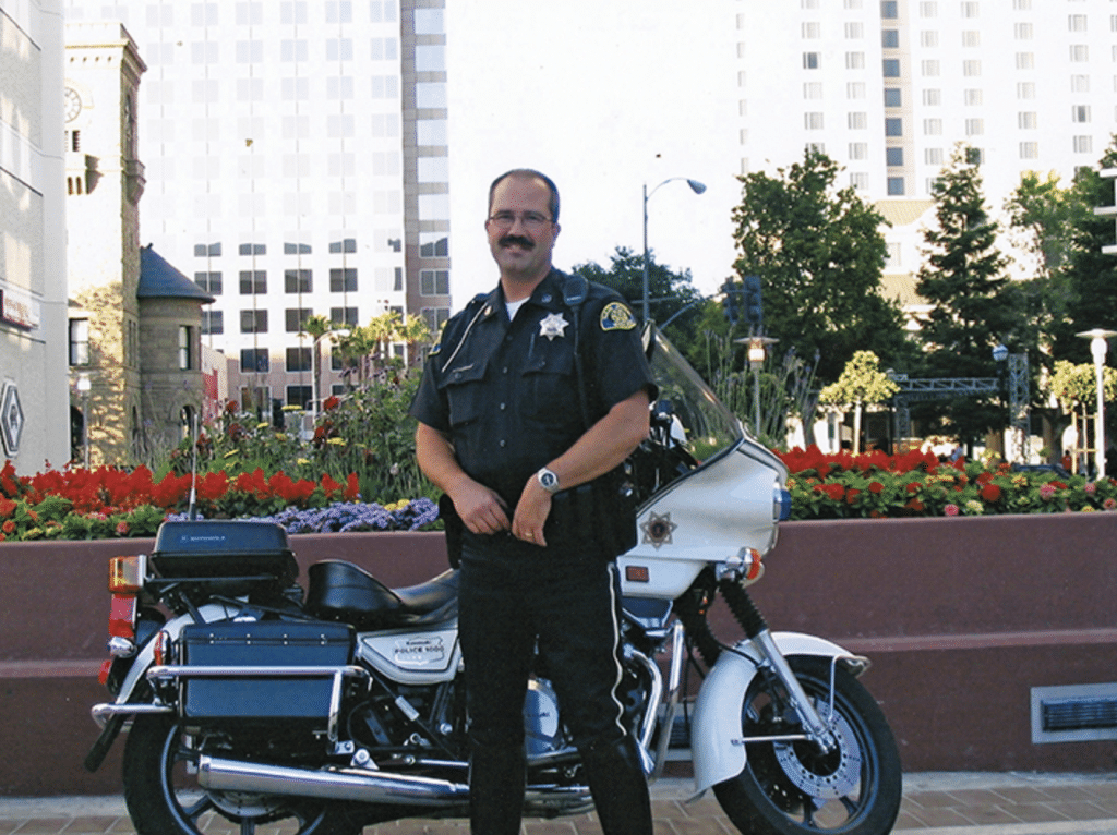 Officer John Cahill poses by his bike