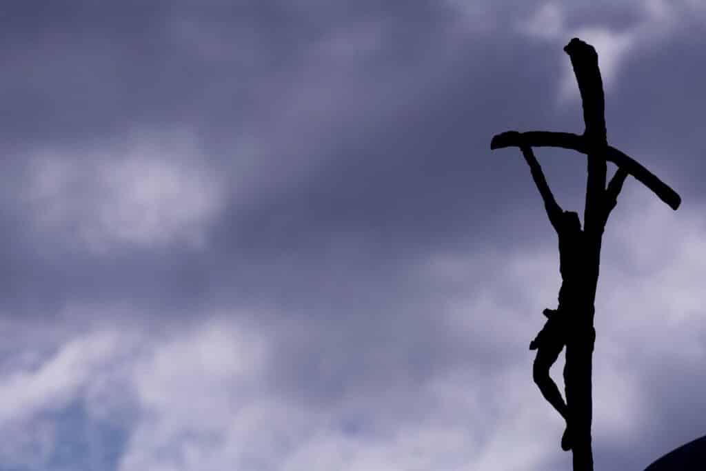 The crucifix of the statue of late Pope John Paul II is silhouetted against the clouds. (OSV News photo/Remo Casilli, Reuters)