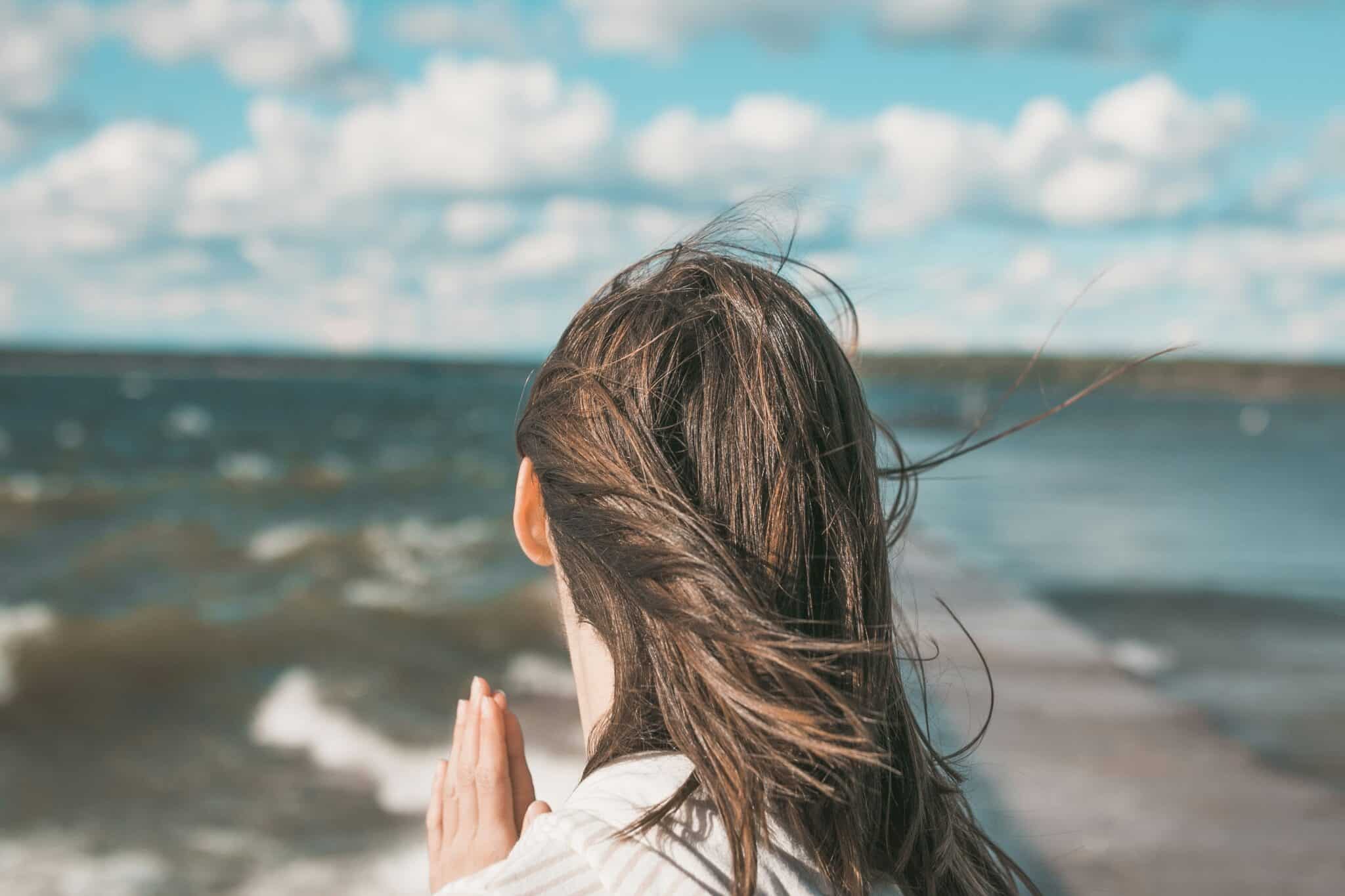 Woman praying | Photo by Joshua Reddekopp on Unsplash