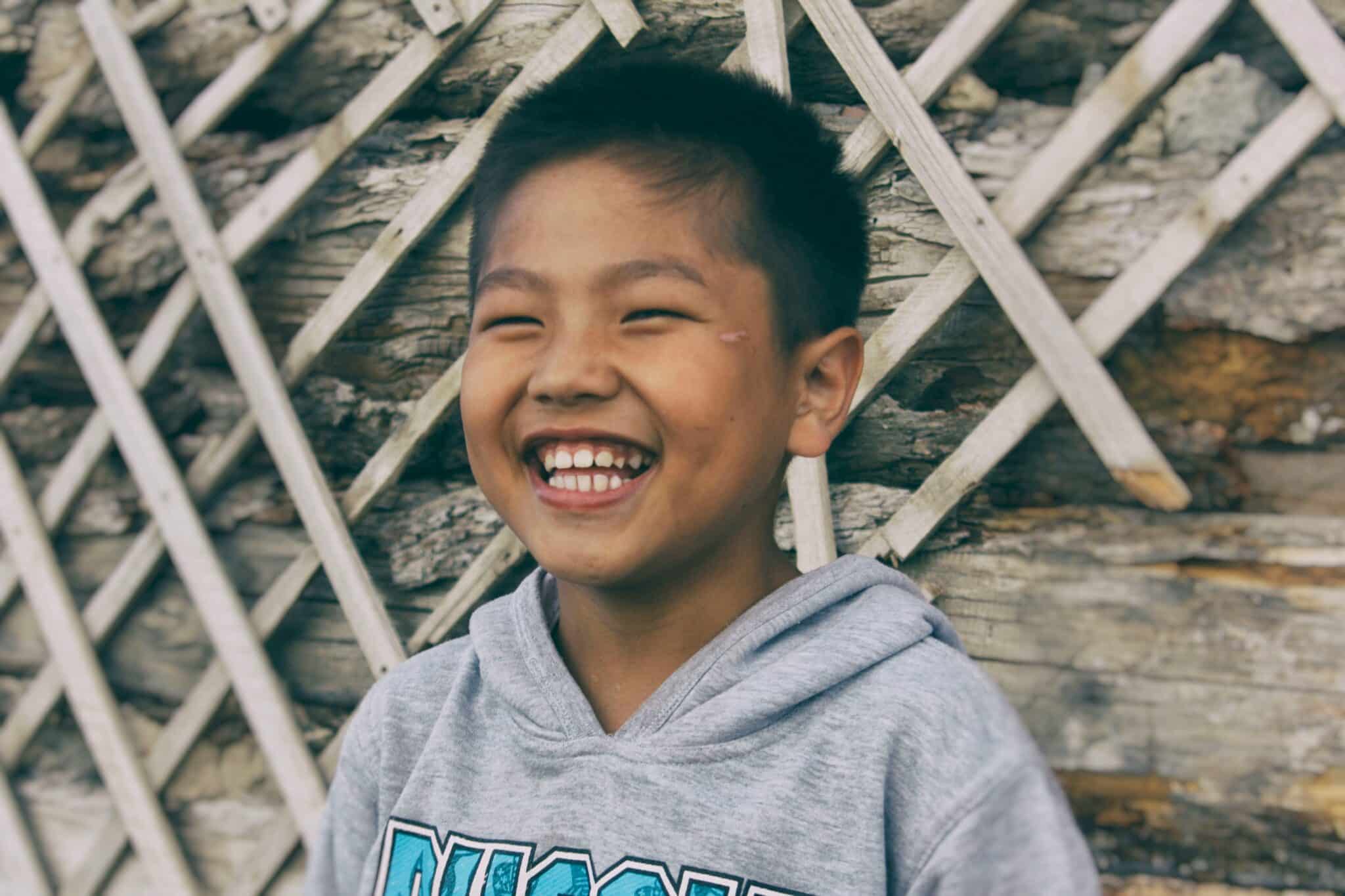 Young kid laughing | Photo by Sane Sodbayar on Unsplash