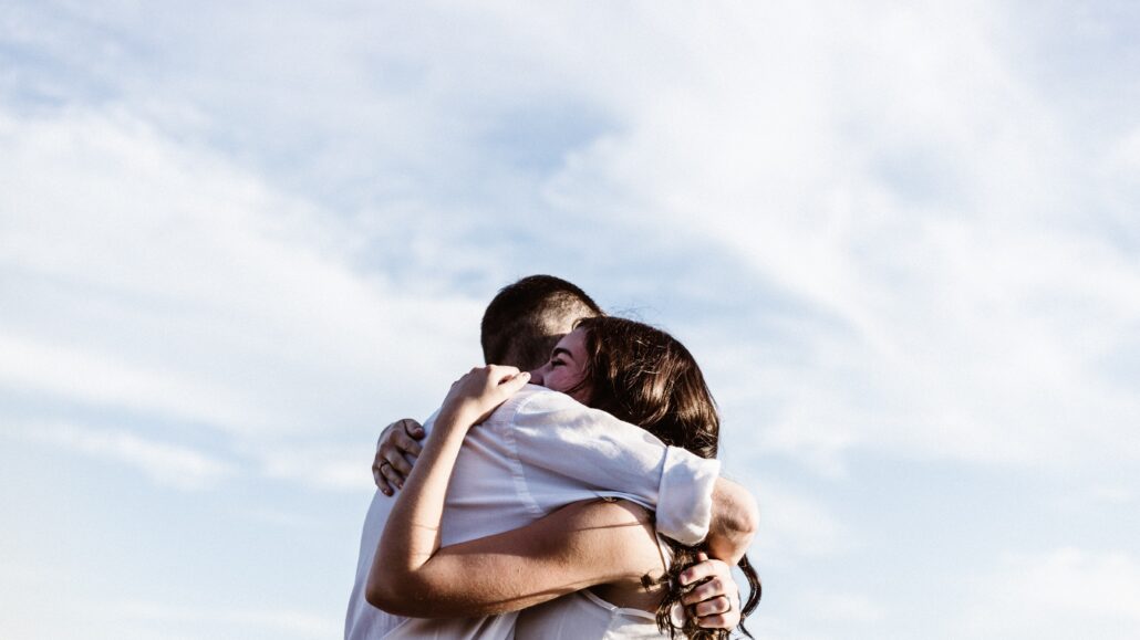 Man hugs a woman