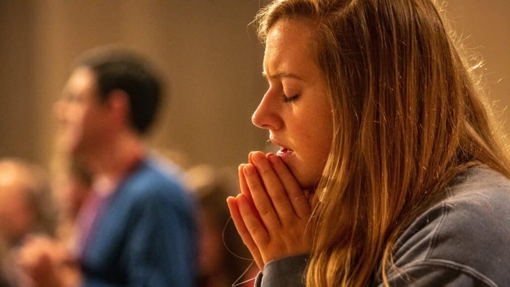 Woman praying at mass