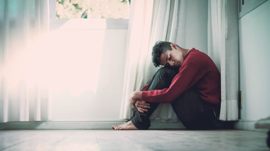 Young person sitting by a window