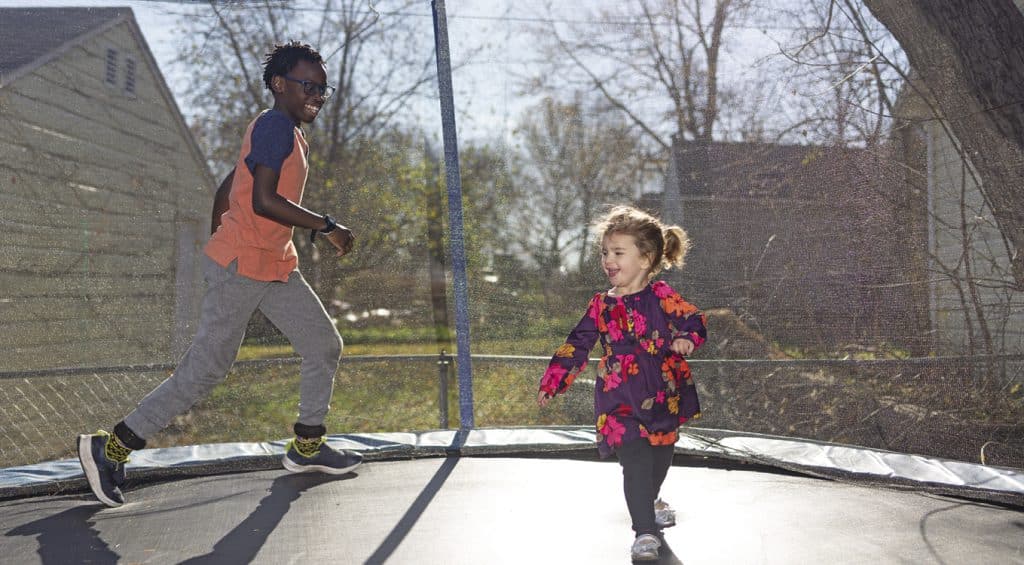 two kids on a trampoline