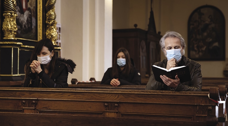 people in masks at church