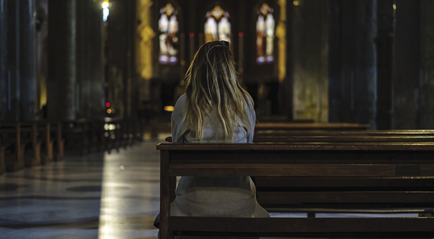 woman sitting alone at church