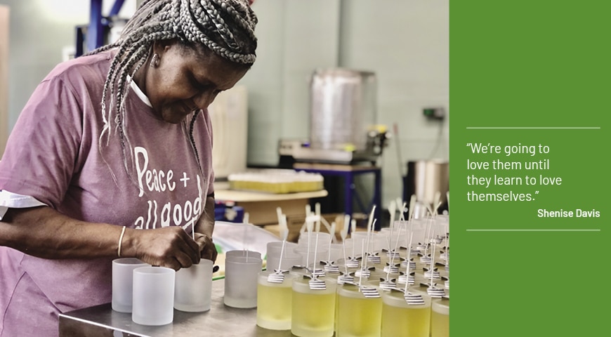 A volunteer at Franciscan Peacemakers makes candles