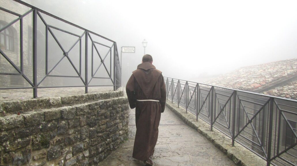 Franciscan friar walking outside of an Italian church