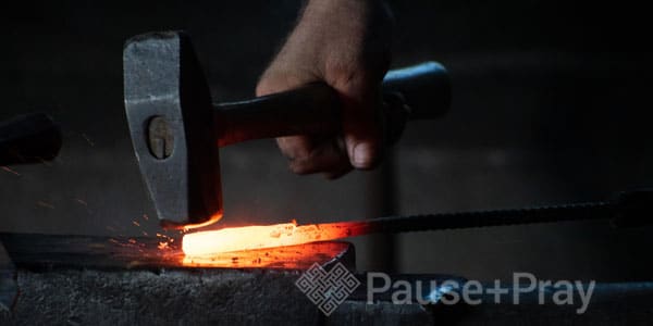 Person forging metal object