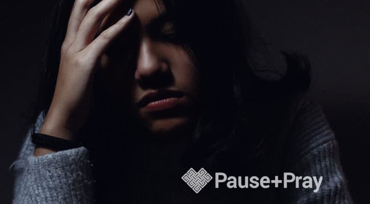 Grieving woman holding her head