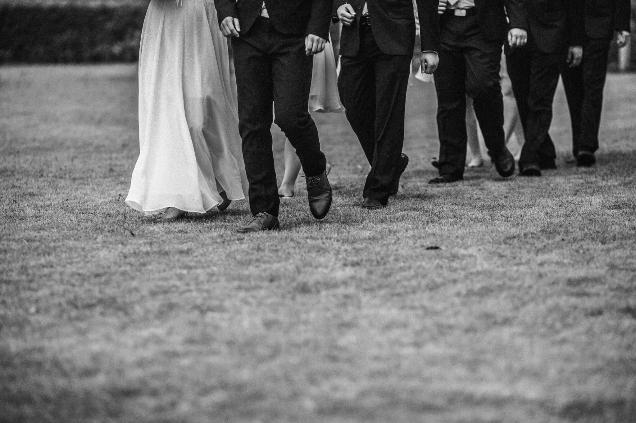 People following the bridge and groom in black and white