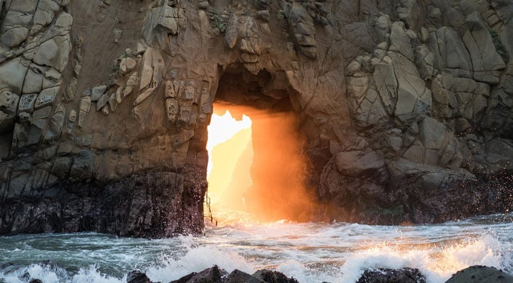 Cave in the ocean with light passing through the entrance